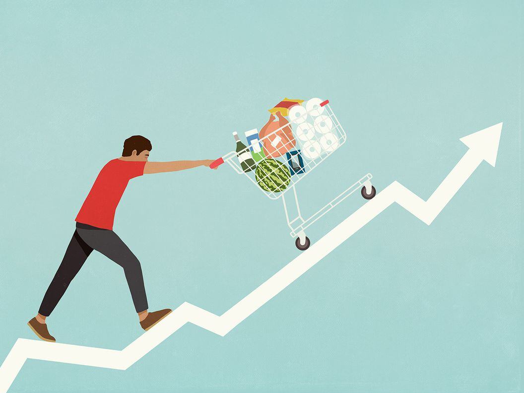 CDCROP: Man pushing shopping cart of groceries up line chart arrow (Getty Images)