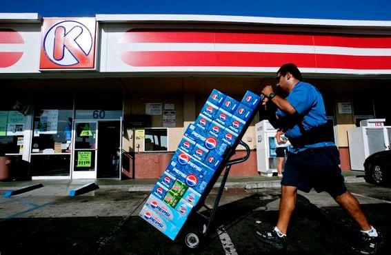 A vendor carts Pepsi products into a Circle K store in Chula