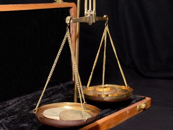 balance scales with coins, weight