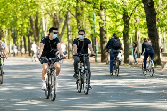 Bikers in Vienna, Austria, don protective masks, April 14, 2020. (Marion Carniel/Shutterstock)