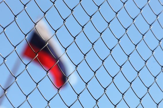 Russian flag behind fence (Shutterstock)