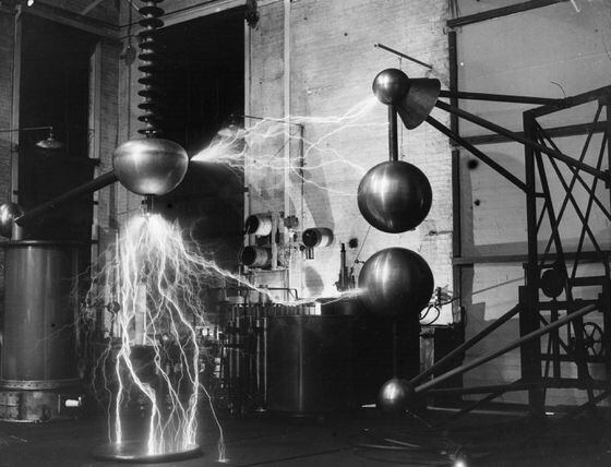 Electricity arcs through the air at the National Physical Laboratory, looking very much like a miniature display of lightning. The image represents Lightning Labs.