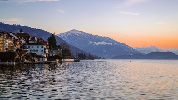 View of Zug, Switzerland, from the lake, with mountains in background. (Louis Droege/Unsplash)