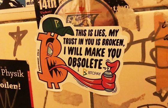 One of the many Bitcoin stickers adorning the men's room.