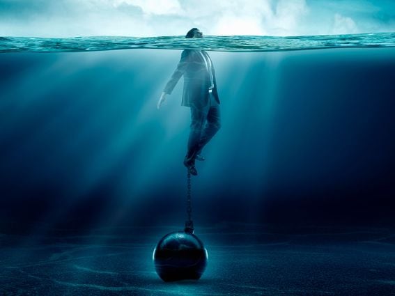 Head Above Water Businessman Ball and Chain Underwater