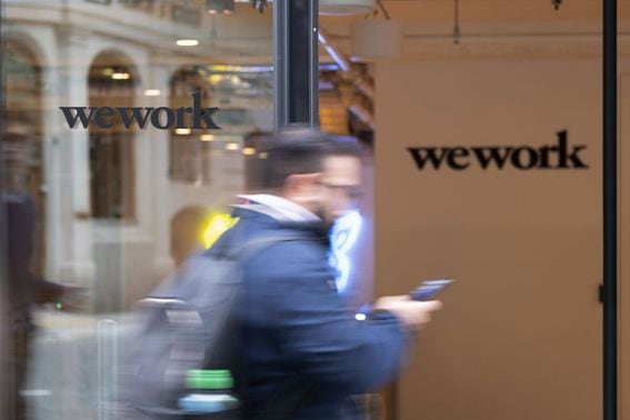 A pedestrian walks past the entrance to the We Work co-working office space, operated by the parent company We Co., on Eastcheap in London, U.K., on Monday, Oct. 7, 2019. While WeWork has been rapidly expanding in Canada, the New York-based company is facing challenges on multiple fronts with Landlords in London and New York the most exposed to any further deterioration at the co-working firm. Photographer: Bryn Colton/Bloomberg via Getty Images