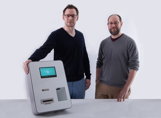  Brothers and co-founders Zach and Josh Harvey with a Lamassu ATM.