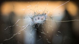 Bullet holes from a Kalashnikov rifle in front windshield. (Getty Images)