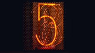 (Anirudh/Unsplash) - picture of the number five in an orange light tint, against a black backdrop.