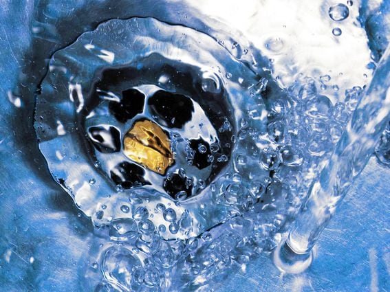 Circling the drain water down washed away (Shutterstock)