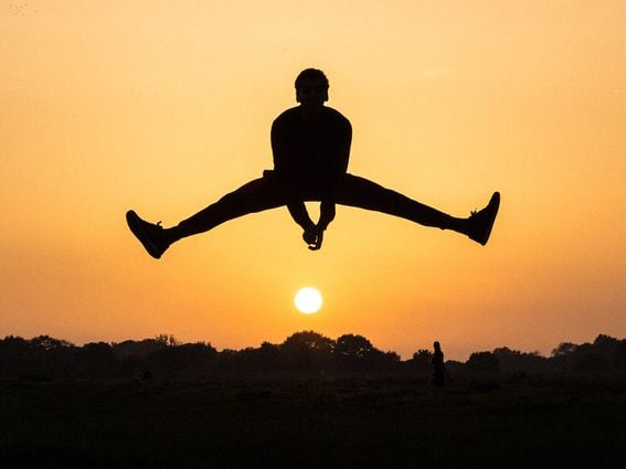 CDCROP: Man leaping over Sun silhouette (Marc Najera/Unsplash)