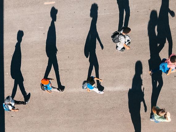Taken from the Sky Lift at the WI State Fair, August 2017 Shadows of people walking extended on the street. (Unsplash)