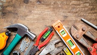 Tool renovation on grunge wood, photo by Isarapic via Shutterstock