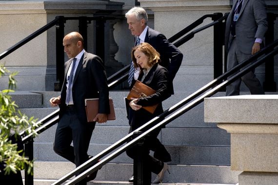 Rostin Behnam, acting chairman of the Commodity Futures Trading Commission, from left, Jerome Powell, chairman of the U.S. Federal Reserve, and Jelena McWilliams, chairman of the Federal Deposit Insurance Corporation, walk to the West Wing of the White House in Washington, D.C., U.S., on Monday, June 21, 2021. President Biden is meeting with the nation's top financial regulators for an update on the state of the country's financial systems and institutions. Photographer: Stefani Reynolds/Bloomberg via Getty Images