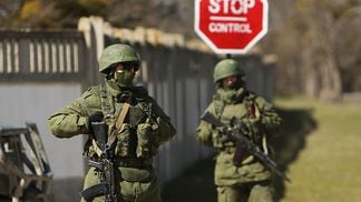 Soldiers outside a military base in Ukraine in 2014. European countries are considering removing Russia from the SWIFT interbank communications network after it invaded Ukraine in late February. (Spencer Platt/Getty Images)