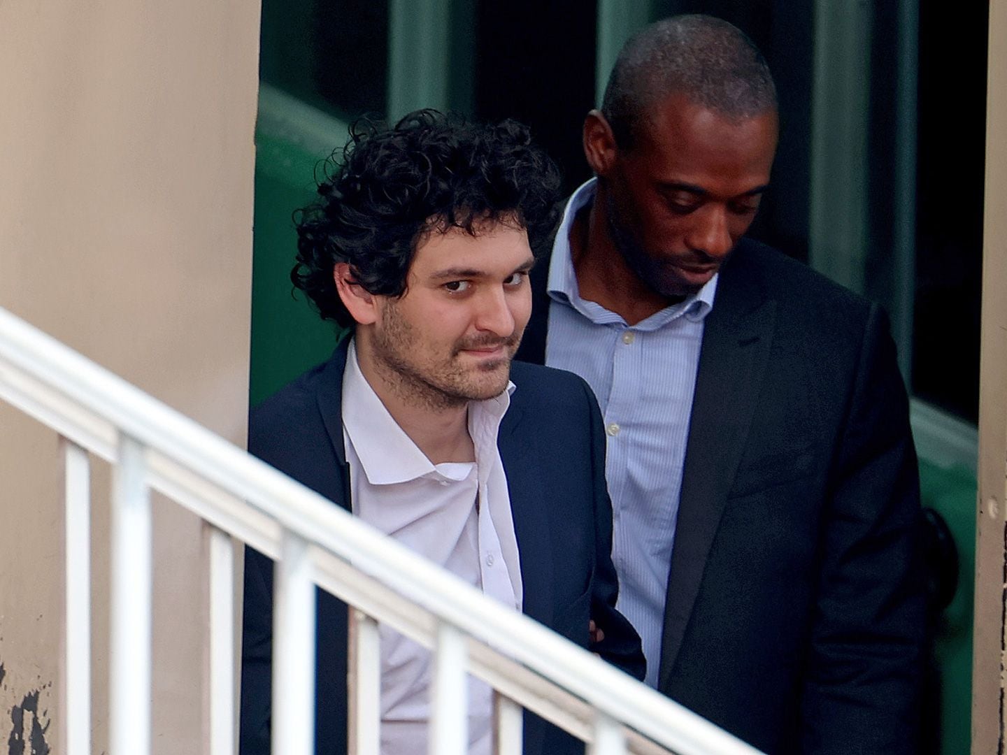 FTX co-founder Sam Bankman-Fried is escorted out of the Magistrate's Court on December 21, 2022 in Nassau, Bahamas. (Joe Raedle/Getty Images)