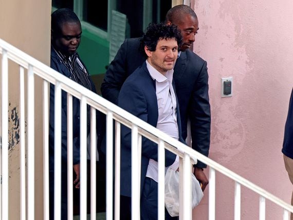 FTX co-founder Sam Bankman-Fried is escorted out of the Magistrate's Court on Dec. 21, 2022 in Nassau, Bahamas. (Joe Raedle/Getty Images)