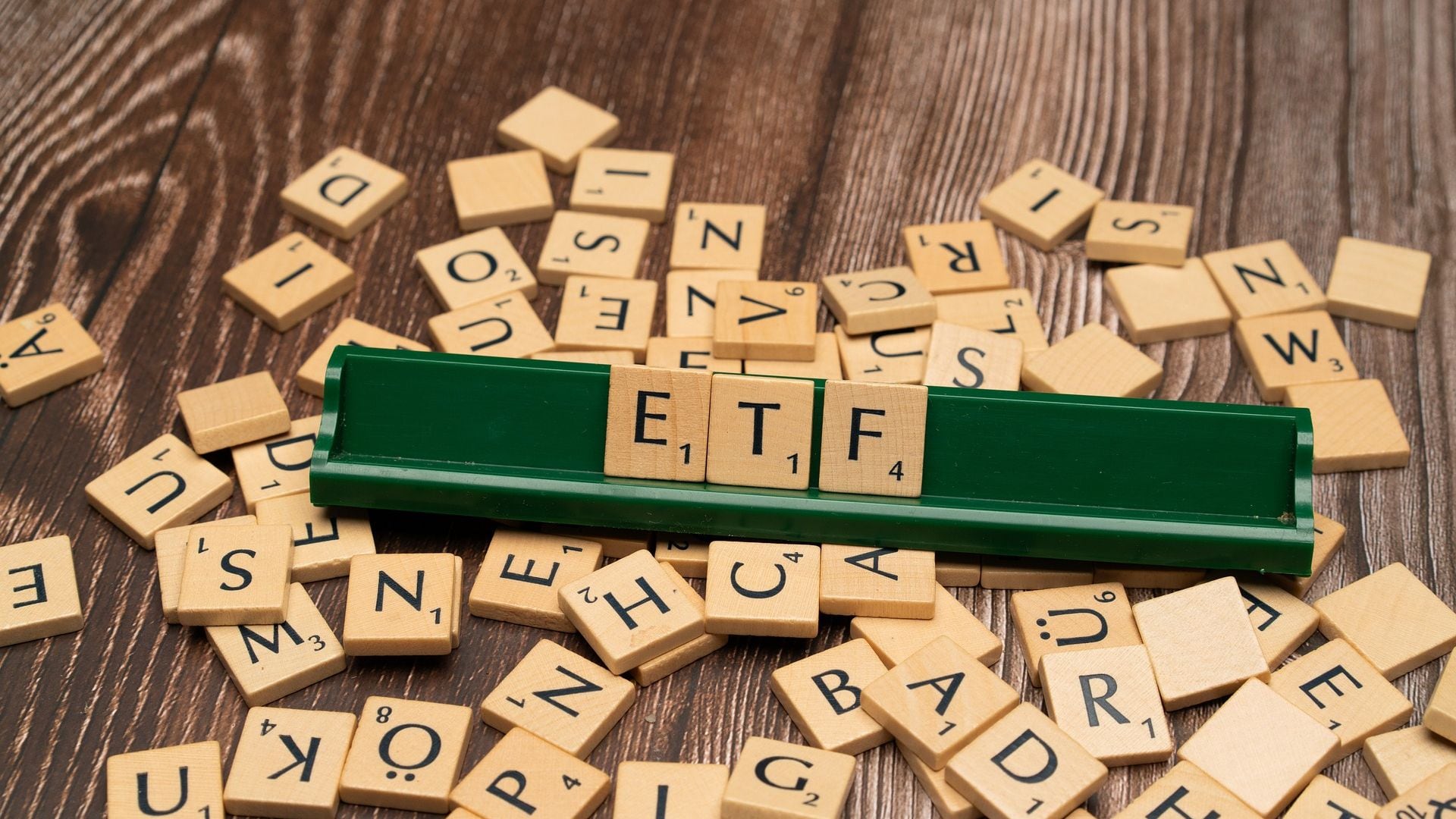 Scrabble letters spelling ETF arranged a rack