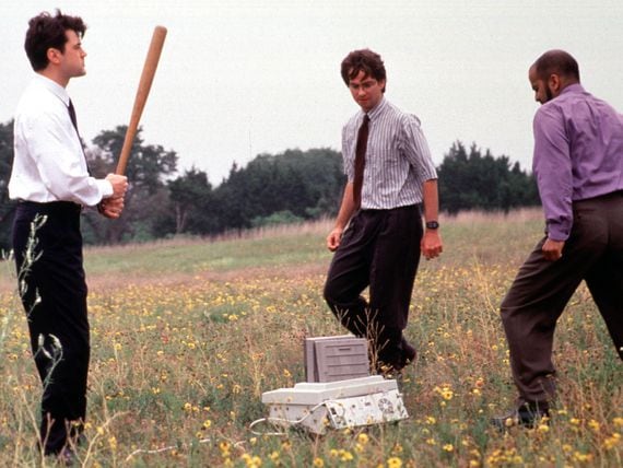 Ron Livingston, David Herman and Ajay Naidu take their ultimate revenge on their dreaded nemesis, the office fax machine in a scene from the 1999 movie "Office Space."  (Getty Images)