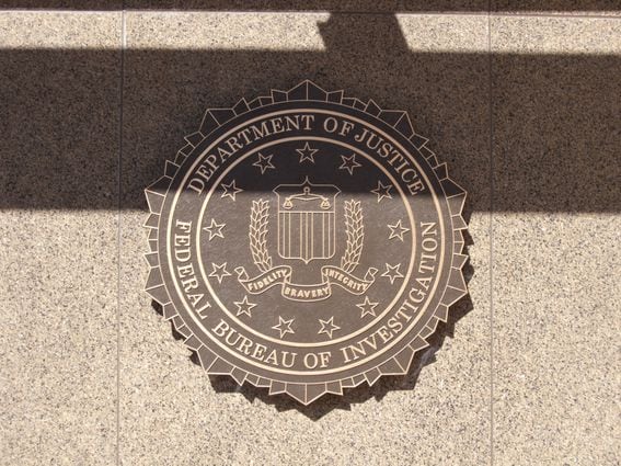 Sign showing FBI emblem at FBI headquarters.