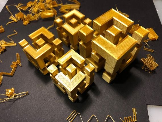 Binance logo, in 3D and printed in gold (Rob Mitchell/CoinDesk)