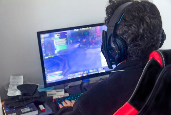 Mature gamer at home playing online games