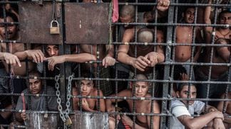SAN SALVADOR, EL SALVADOR - MAY 20:  MS-13 gang members languish in one of the three 'gang cages' in the Quezaltepeque police station May 20, 2013 in San Salvador, El Salvador. These overcrowded, 12x15 cages were designed to be 72-hour holding cells for common criminals and the two rival gangs, but many of the individuals have been imprisoned for over a year.  (Photo by Giles Clarke/Getty Images.)