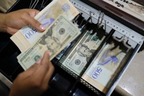 Dollar bills in the cash drawer of a bakery shop Caracas, Venezuela 
