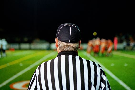 American football referee on field, rear view (Darrin Klimek/Getty Images)