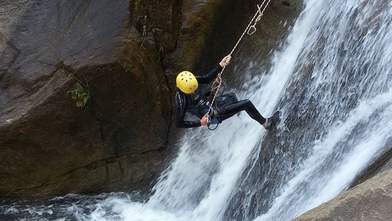Person climbing up a waterfall