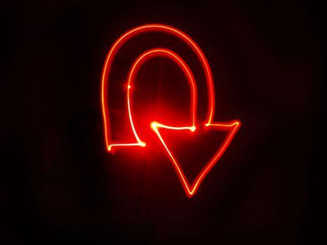 CDCROP: U turn arrow bright red light painting (Getty Images)