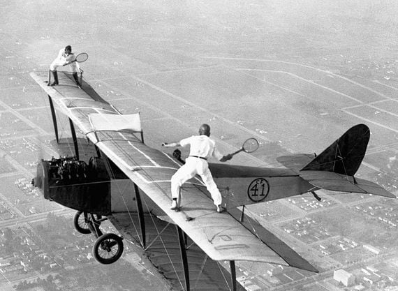 Gladys Roy plays tennis with Ivan Unger (member of the "Flying Black Hats") as Frank Tomac pilots the plane at 3,000 feet. The only problem with this match is trying to retrieve a ball after it has bounced off the wing of the plane and plunged a few thousand feet.