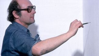 Artist Sol LeWitt with one of his instruction-based wall drawings in 1978. LeWitt is widely credited for his influence on the field of "generative art," which has benefited from NFT technology.