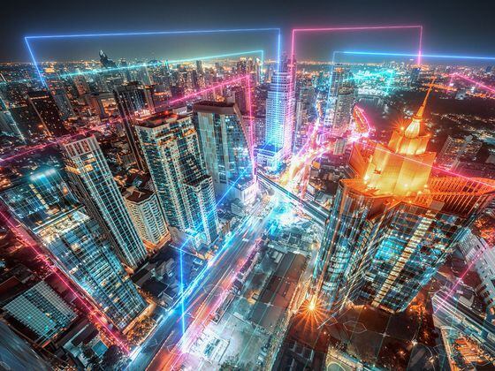 CDCROP: Night cityscape with Neon light and  Futuristic digital design (Getty Images)
