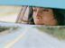 CDCROP: Woman driving car reflected in rear view mirror, close-up (Justin Pumfrey/Getty Images)