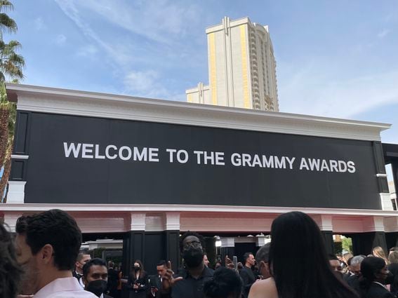 Attendees of the Grammy Awards mingle on the red carpet.