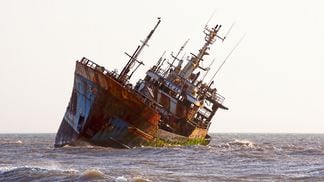 Image of a shipwreck in shallow water.