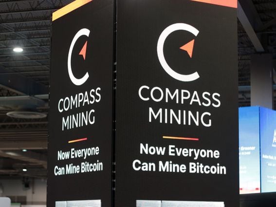 Compass Mining's booth at the Mining Disrupt conference in Miami in July. (Eliza Gkritsi/CoinDesk)