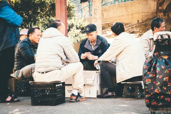 Street gambling in Chinatown, San Francisco. Gambling is a huge part of human society - but it comes with significant  downsides for some.