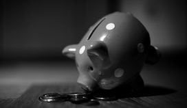 CDCROP: Piggy bank bent forward change money coins (Andre Taissin/Unsplash, modified by CoinDesk)