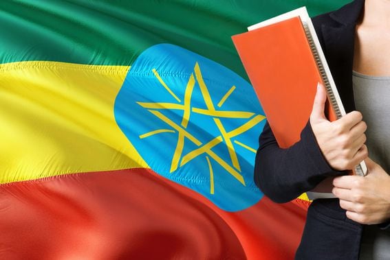 learning-ethiopian-language-concept-young-woman-standing-with-the-ethiopia-flag-in-the-background-teacher-holding-books-orange-blank-book-cover