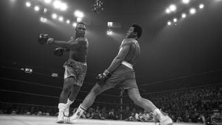 Muhammad Ali ducks a roundhouse left thrown by Joe Frazier during their title bout in 1971.