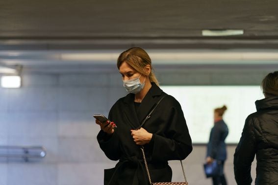BEFORE THE 'CYBER GULAG': A young woman in Moscow wearing a medical mask on March 25, four days before the city imposed a lockdown. People wanting to leave their homes now need electronic permission. (Credit: Shutterstock)
