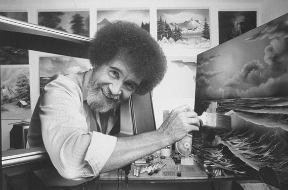 TV painting instructor/artist Bob Ross using a large paint brush to touch up one of his large seascapes in his studio at home.  (Photo by Acey Harper/Getty Images)