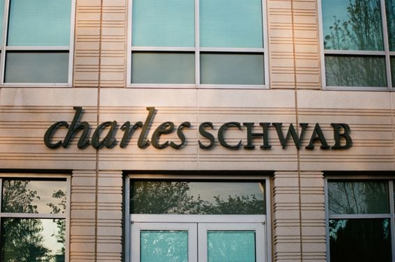 Close-up of sign with logo at Charles Schwab financial adviser branch in Pleasanton, California.