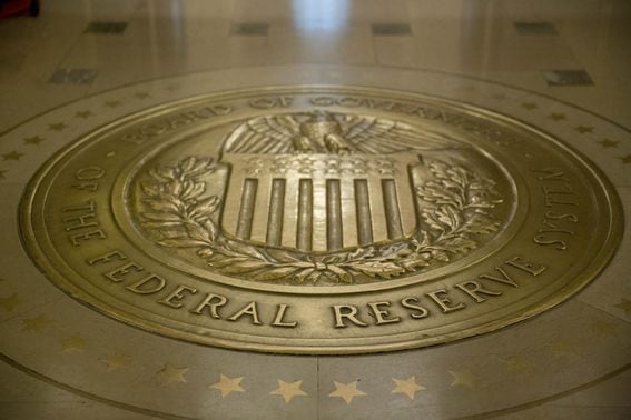 The Board of Governors of the Federal Reserve seal is displayed on the floor outside the board room in Washington, D.C., U.S., on Monday, Nov. 30, 2015. The Federal Reserve took the final step to ensure it can't repeat the extraordinary steps taken to rescue American International Group Inc. and Bear Stearns Cos. in 2008, adopting formal restrictions on its ability to help failing financial firms. Photographer: Andrew Harrer/Bloomberg via Getty Images