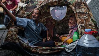 Afghan refugees in Indonesia. Banking bans and a lack of cryptocurrency infrastructure will add major barriers to Afghans trying to send money home. (Getty Images)