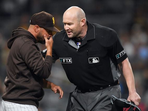 SAN DIEGO, CA - JULY 29: San Diego Padres manager Jayce Tingler talks with umpire Mike Estabrook during the sixth inning of a baseball game at Petco Park on July 29, 2021 in San Diego, California.  (Photo by Denis Poroy/Getty Images)