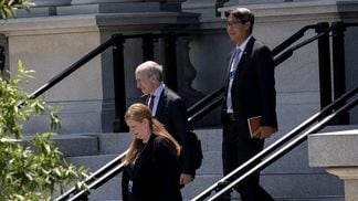 Gary Gensler, chairman of the U.S. Securities and Exchange Commission, center, and Michael Hsu, acting head of the Comptroller of the Currency, right, walk to the West Wing of the White House in Washington, D.C., U.S., on June 21, 2021. 