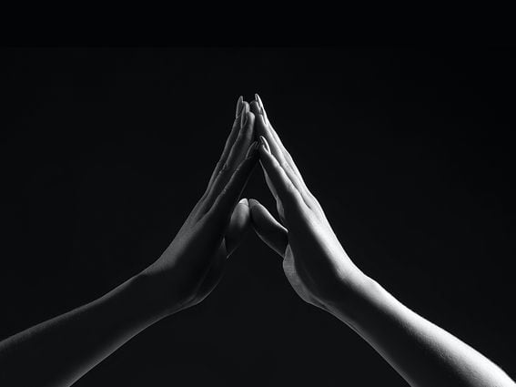 Two hands coming together, representing the Merge on Ethereum.